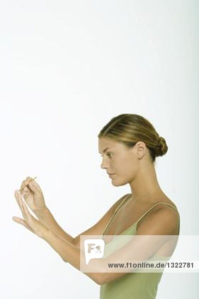 Young woman cleaning cuticles