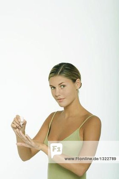 Young woman polishing nails