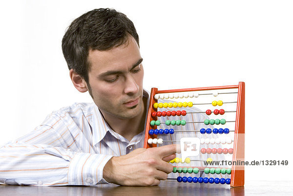 Young man working with abacus