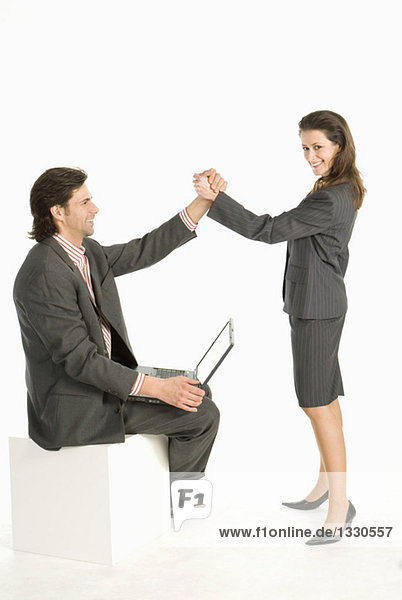 Business colleagues giving high five  smiling  side view