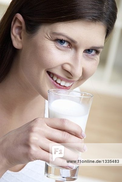 Woman holding a glass of milk in her hand