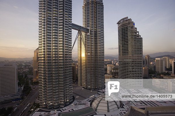 Twin skyscrapers in city at dusk  Petronas Towers  Kuala Lumpur  Malaysia