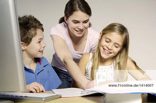 Brother and sisters studying and smiling