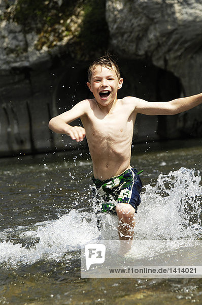 Boy running in river
