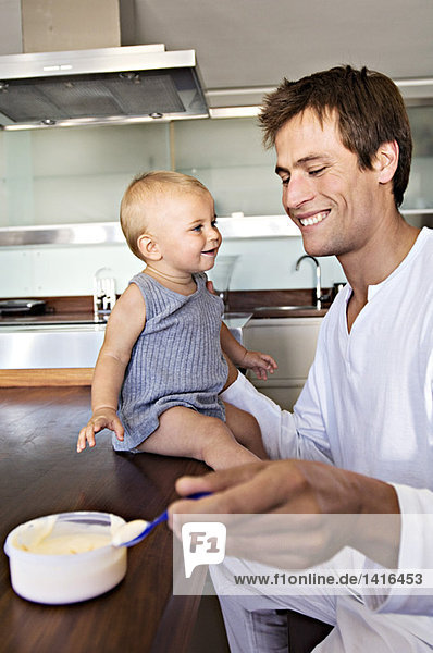 Father and son in kitchen  indoors