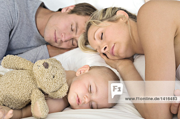 Father  mother and baby sleeping  indoors