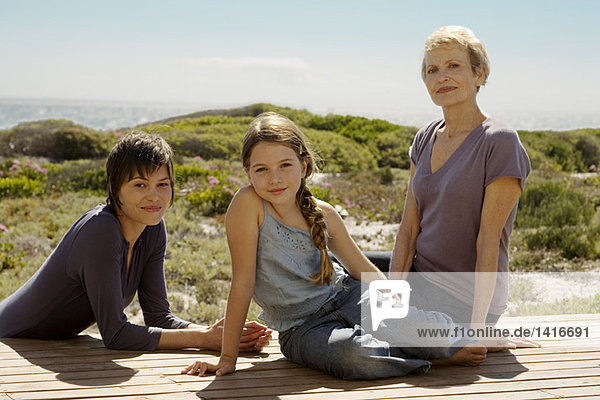 Female members of three generation family looking at camera  outdoors