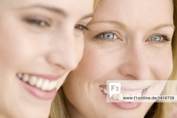 Portrait of two smiling women  indoors
