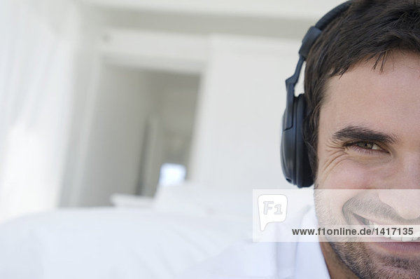 Portrait of a young man listening to music with headphones