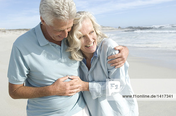 Smiling couple embracing on the beach