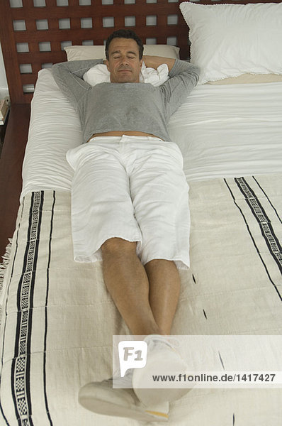 Man lying on a bed  indoors