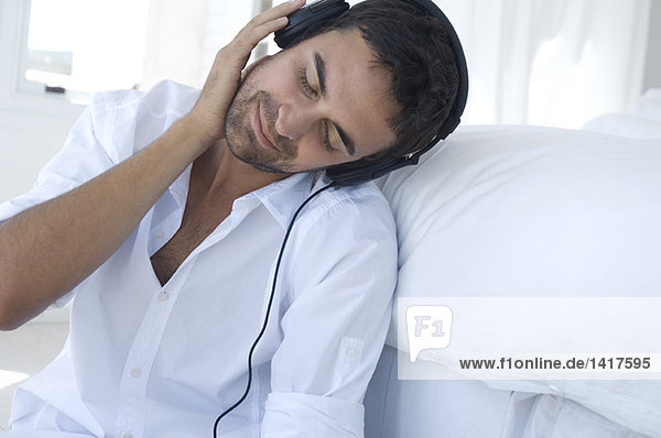 Young man listening to music with headphones