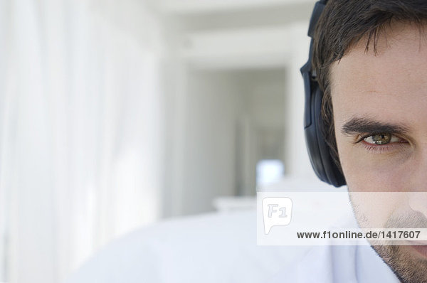 Portrait of a young man listening to music with headphones