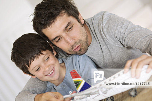 Father and son playing with model aeroplane