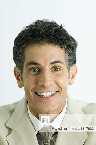 Man looking at camera with toothy smile  head and shoulders  portrait