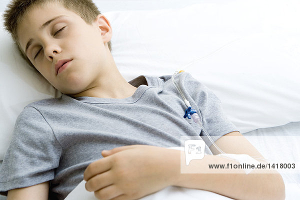 Junge schläft im Krankenhausbett  IV im Arm