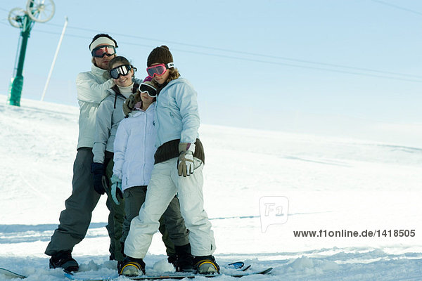 Young snowboarders standing together  full length portrait