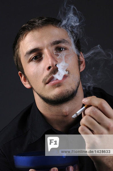 Man lighting a cigarette  portrait