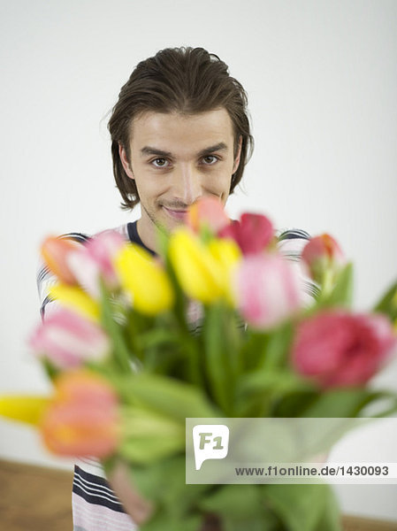 Man holding bunch of flowers