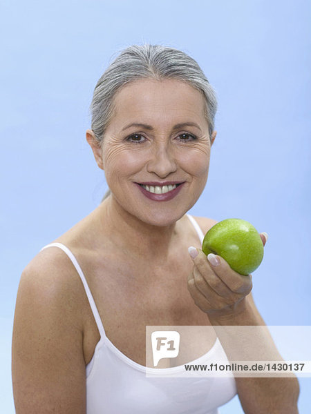Frau hält grünen Apfel  Portrait