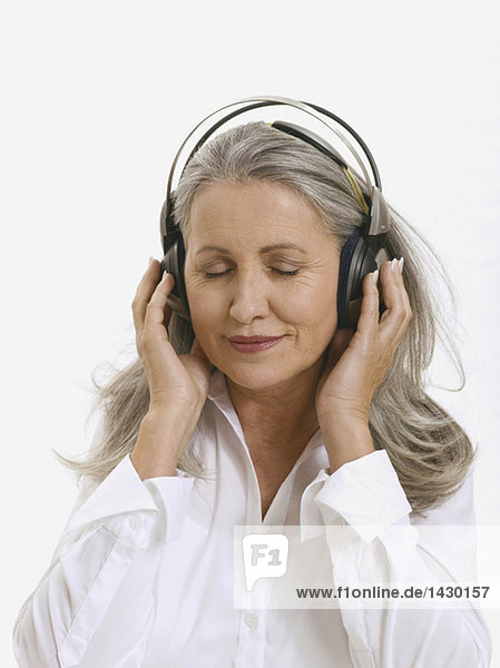 Senior woman wearing headphones  portrait