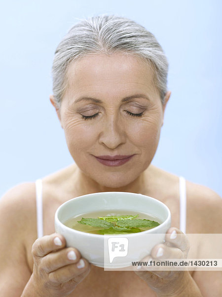 Senior woman holding tea bowl  portrait