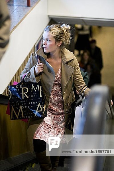Woman in an escalator in a mall Stockholm Sweden.