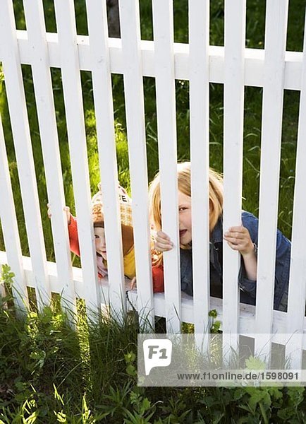 Two children behind a fence Sweden.