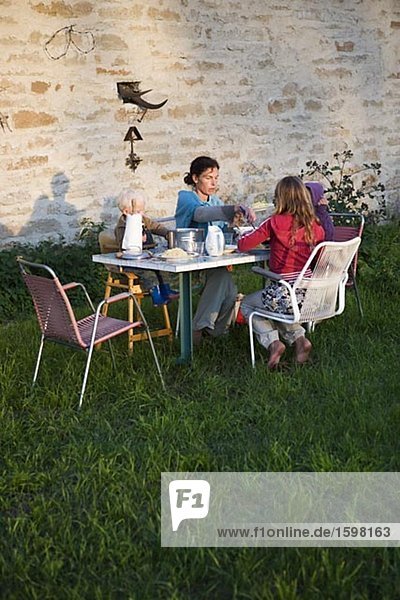 Family having dinner outdoors Oland Sweden.