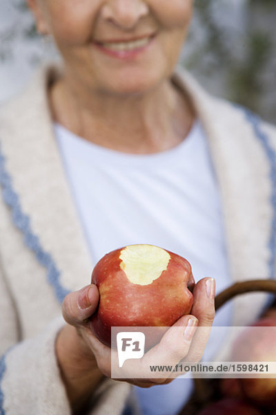 Woman holding an apple in her hand Sweden.