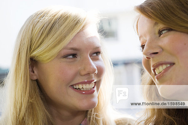 Two smiling teenage girls.