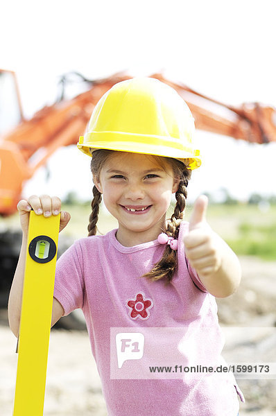 Portrait of girl wearing hardhat and smiling