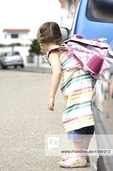 Side profile of girl carrying schoolbag