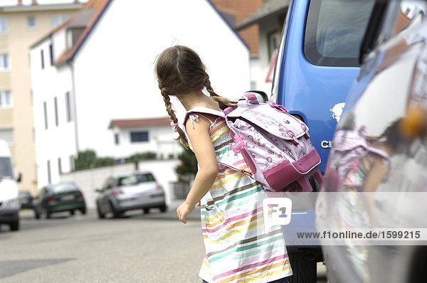 Side profile of girl carrying schoolbag