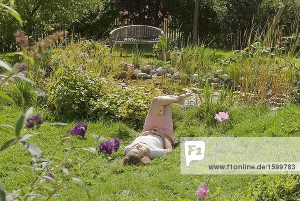 Woman lying in lawn