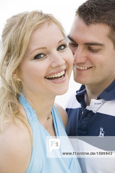 Close-up of young couple smiling