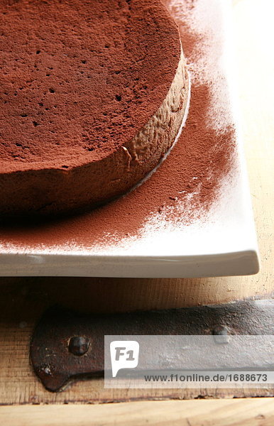 Chocolate powder being sprinkled over cake