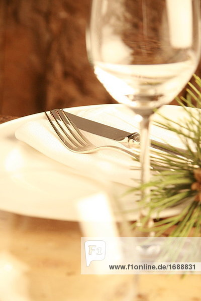 Close-up of table knife and fork on napkin