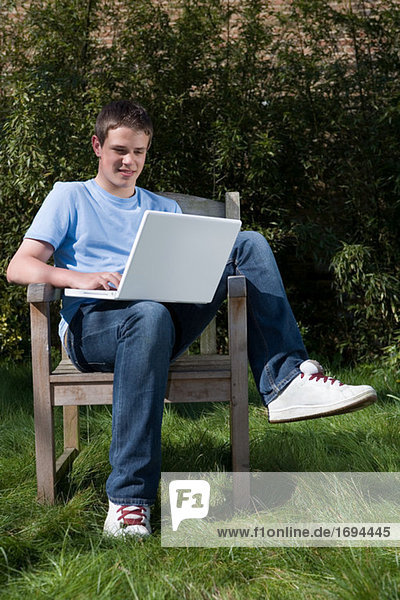 Teenage boy using laptop