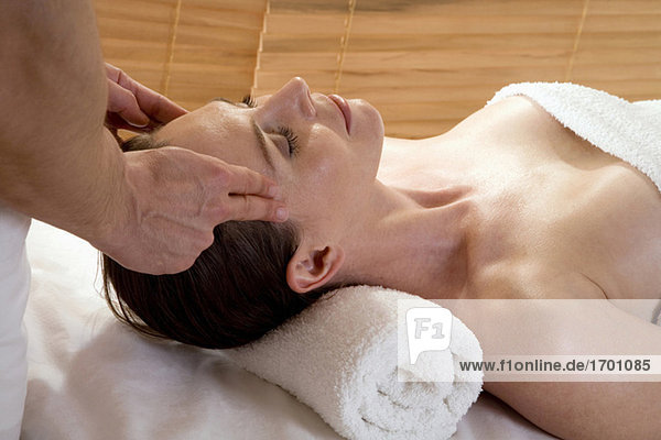 Woman receiving facial massage
