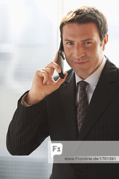 Business man  using mobile phone  close-up
