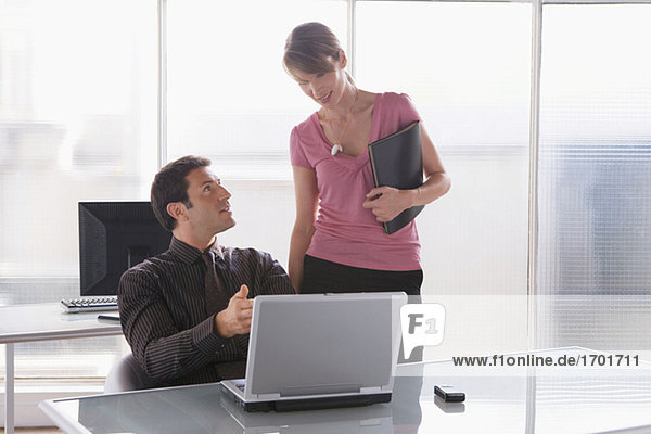 Geschäftsfrau und -mann bei der Arbeit am Laptop  Teamarbeit