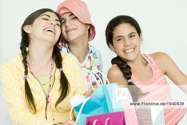 Three young female friends with gift bags