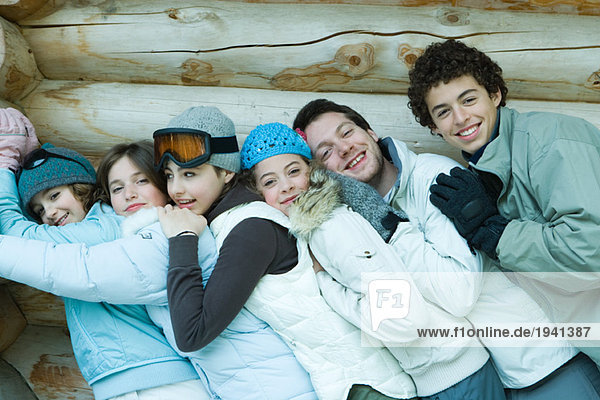 Group in winter clothes  leaning against each other  waist up  portrait
