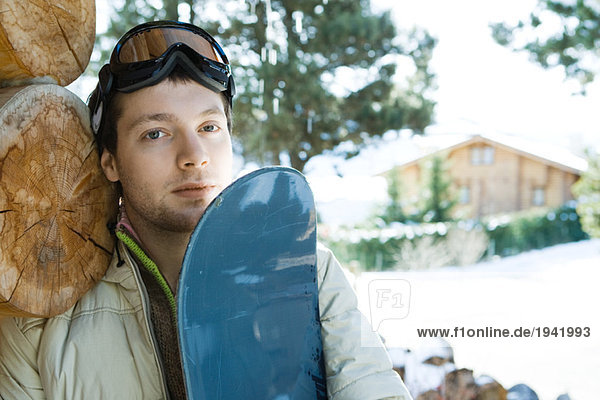 Young man with snowboard  portrait