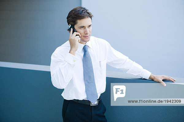 Businessman using cell phone  waist up