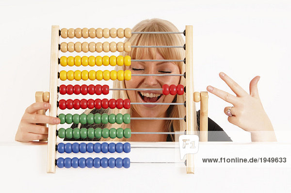 Young woman holding abacus