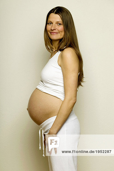 Pregnant woman smiling  side view