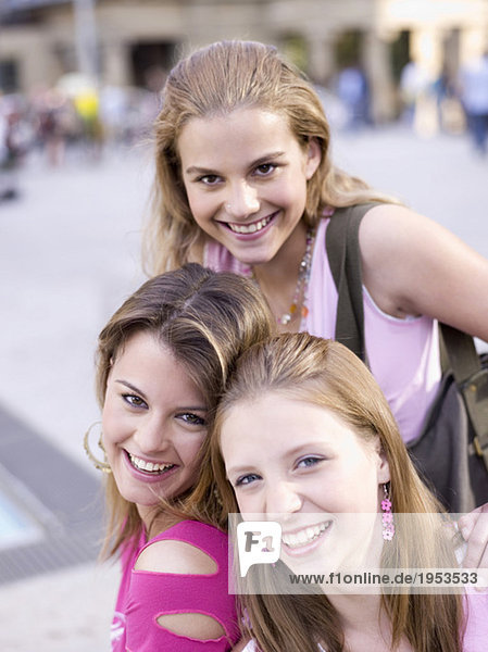 Three teenage girls (16-17) smiling