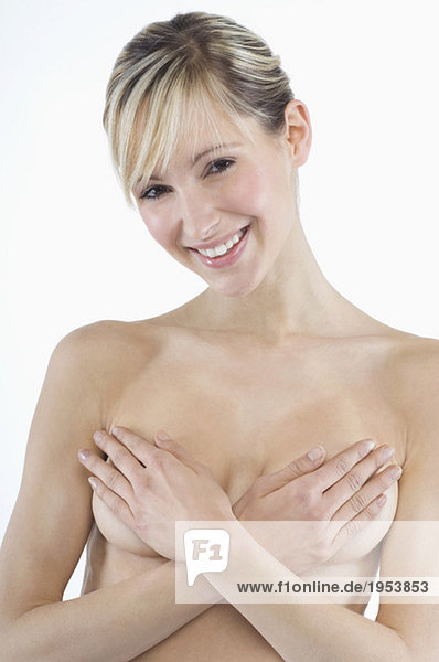 Young woman covering breasts  portrait